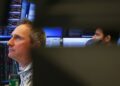 Shares acquire, gold sags on commerce deal optimism